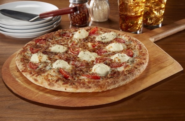A Barro's white pizza on a wooden board